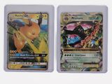 two pokemon cards are sitting side by side on a white surface