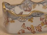 a close up of a glass bowl with flowers on it