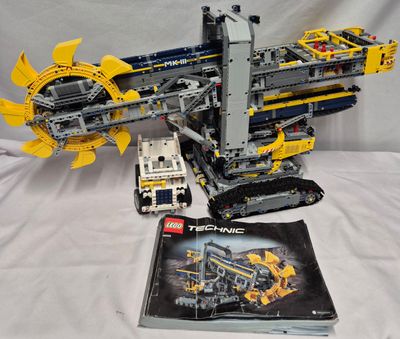 a lego model of a crane and a book on a table