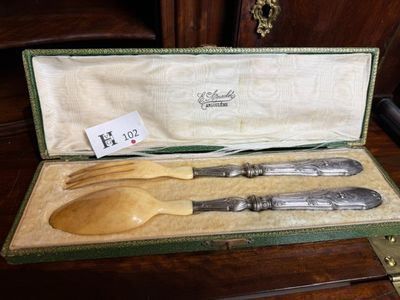 two wooden spoons and a fork in a case