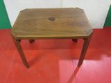 a small wooden table with a hole in the top