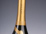 an old bottle of champagne with a gold ribbon around the top