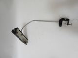 a metal hook attached to a wall with a light on it