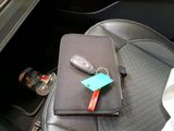a car seat with a cell phone and a bottle of water on it