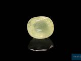 a green quartz stone on a black surface
