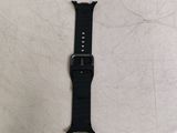 the apple watch is laying on a table with a black strap