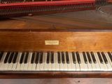 a piano that is sitting on a table next to a piano