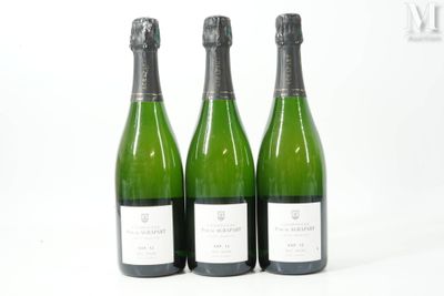 trois bouteilles de vin posées les unes à côté des autres sur une surface blanche