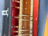 a guitar inside of a case on the floor