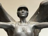 a statue of a woman with wings on a pedestal