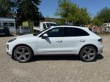 the white porsche cayen is parked in the parking lot