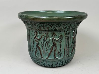 a green vase that has a design on it