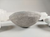 a large rock sitting on top of a table next to other rocks