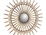 the sunburst mirror is made out of wood sticks and has a mirror in the middle