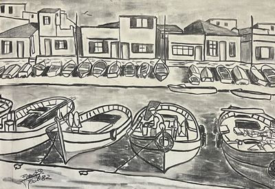 many boats in the water near a row of buildings