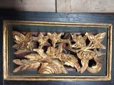 a picture of a picture of a wood carving on the wall