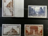 four different stamps from different countries on display in a glass case
