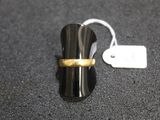 a ring with a gold band sitting on top of a black surface