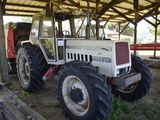 a tractor that is parked under a shelter