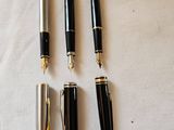 four different types of pens are lined up on a white cloth