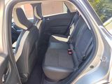 the back seats of a silver car with a black seat belt