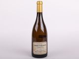 a bottle of wine sitting on top of a white table