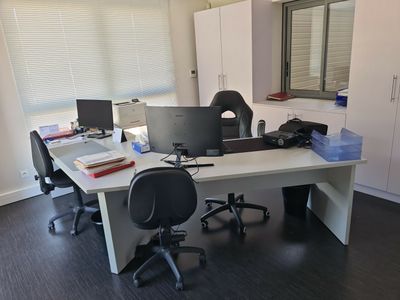 a desk with two computer monitors and a laptop on it