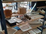 many plates and trays on the shelves in the kitchen