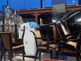 a lot of chairs and a table in a warehouse