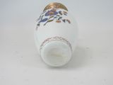 an image of a white vase with blue flowers on it