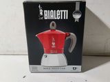 emballage d'une cafetière rouge et blanche posée sur une table blanche