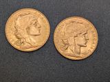 two gold sovereigns, one of which is a woman and one of which is a man
