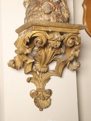 a gold clock on the wall next to a clock on the wall
