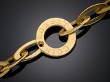 a close up of a gold bracelet on a black surface