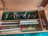 a wooden box with a bunch of figurines in it