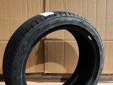 tire on the floor in front of a cardboard box with a cardboard box in the background