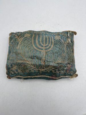 a close up of a small piece of cloth with a menorah on it