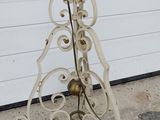 a tall metal pole with a flower on top of it