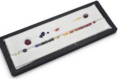 a close up of a display case with a bunch of different colored stones