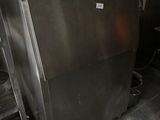 a large metal refrigerator in the middle of a kitchen