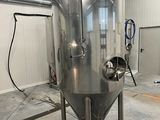 an image of a large stainless steel tank in a building