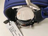 a close up of a wrist watch with a tag on it