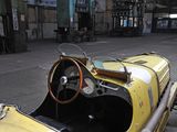 a yellow car that is sitting in a garage