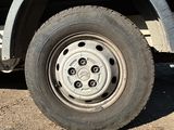 a truck with a flat tire parked on the side of the road