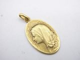 a close up of a gold medal with a woman ' s face on it