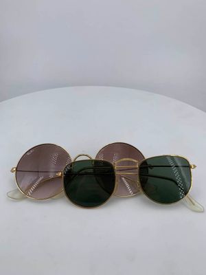 three pairs of sunglasses sitting on top of a white table
