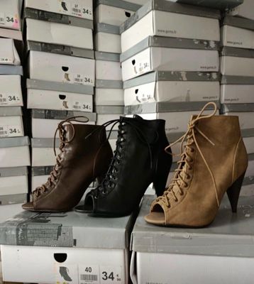 several pairs of women ' s shoes are stacked on top of each other