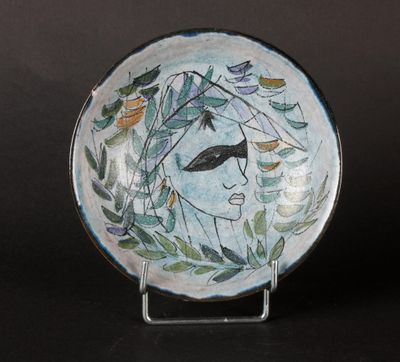 a plate with a woman ' s face painted on it