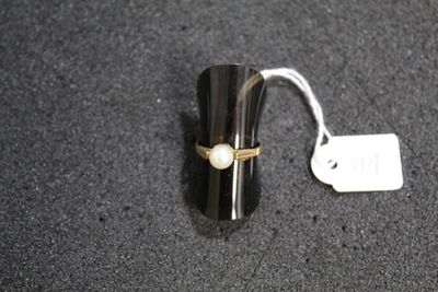 a close up of a ring on a black surface with a price tag