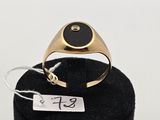 l'image d'une bague en or ornée d'une pierre noire